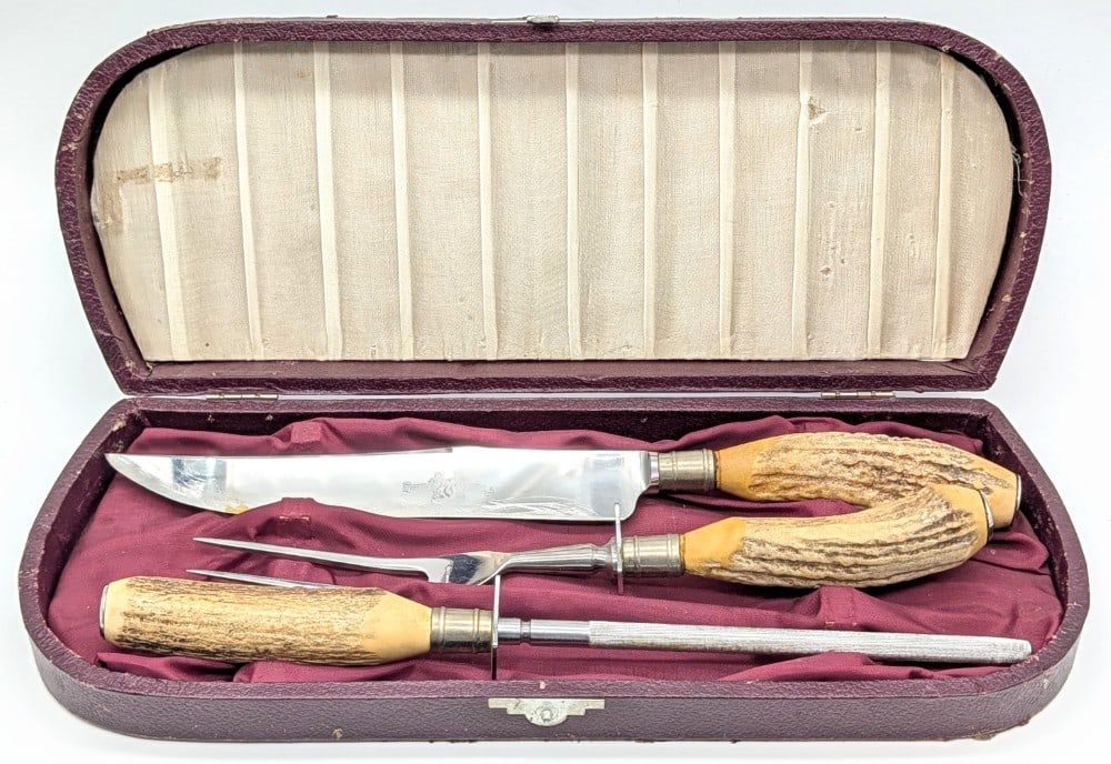 Antique Stag Stainless Steel Carving Knife Set w/ Case: Both the knife and fork are marked stainless steel with no maker. Pieces are in good condition with scratches on the blade, and general tarnishing from use and age. Blade length measures 8-1/2in and