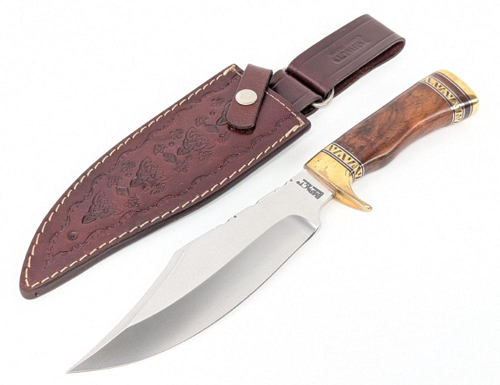 Impact Custom Knives Smooth Wood Bowie Knife w/ Sheath: Features a satin finish clip point blade with file work on the spine, a brass single downturned guard, file worked brass handle spacers, a smooth wood handle, and a brass butt cap. Knife is in very ni