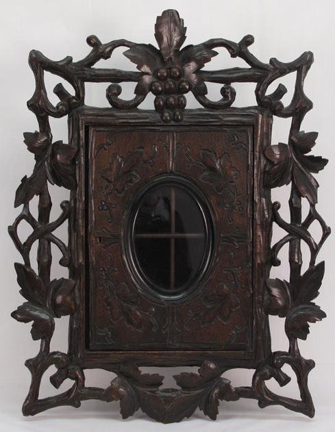 Black Forest Carved Wood Wall Cabinet: Black Forest Carved Wood Wall Cabinet: Black Forest Carved Wood Wall Cabinet. Ornately chipped carved. Size: 22"H x 17"W. Condition: Top leaf has been re-glued, missing key.