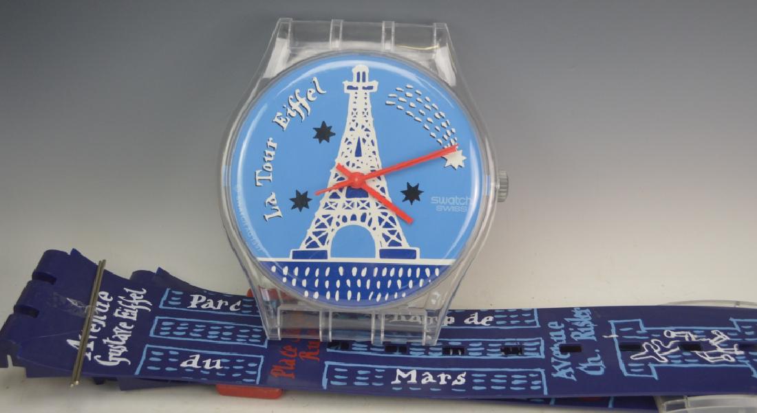 Swatch Swiss Wall Display: Includes Swatch Swiss watch, ''La Tour Eiffel'' battery operated approx. 84'', face 11'' in diameter