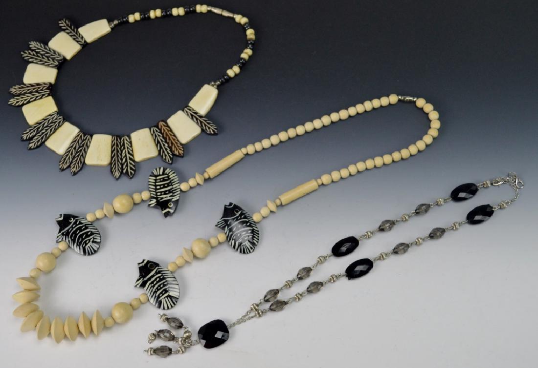 Costume Jewelry Necklace Grouping: Includes (3) Necklaces. (2) Carribean faux coral and or wood beads. (1) Silver and faux ebony beads. Measures 29"l