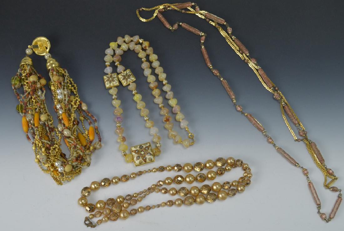 Costume Jewelry Necklace Grouping: Includes (4) costume jewelry necklaces. (1) beaded choker . (3) Necklaces. (1) is jade type. (2) beaded. Measures 34"L
