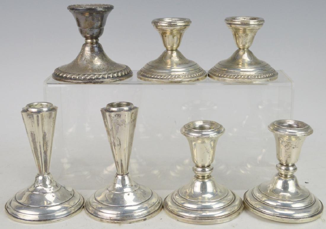 Sterling Silver Candlestick Grouping: Includes (3) matching pairs with one odd piece. Tallest pair is Rogers and measures 4.25", next is Frank Whiting and 3.5", smallest is just marked sterling, odd piece is Rogers. Some have dents and wa