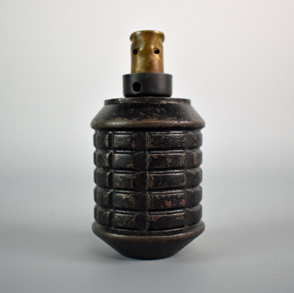 WWII Japanese Grenade: This beautiful piece is a rare Japanese Hand grenade Model Type 97 with a rare Label. It has Japanese Kanji marked on the bottom and it also has the scarce Type 99 'kiska' Grenade fuse. It is a vetera