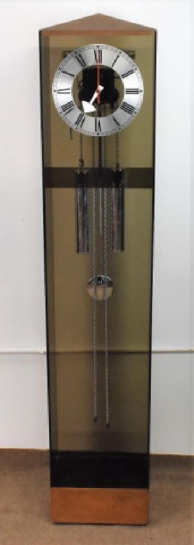 Howard Miller Mid Century Clock: Mid Century Modern Walnut Acrylic Tallcase Clock made by Howard Miller, Made in Germany, measuring: 60" x 12" x 8"