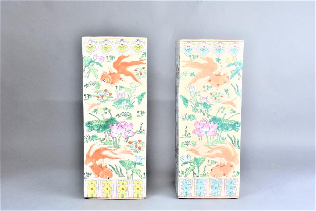 Pair of Chinese Vases: Includes (2) vases that were drilled to be lamp bases, decorated with Chinese village scenes, gateways, as well as koi and plant life. Rests on a wood base. Total height is approx. 23"h