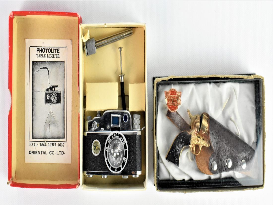 Miniture Camera & Cap Gun Grouping: Consisting of; "Photo Lite", Table Lighter in the form of a camera with tripod, in original box. Miniature Revolver style Cap Gun with leather holster, mark Made in Japan.