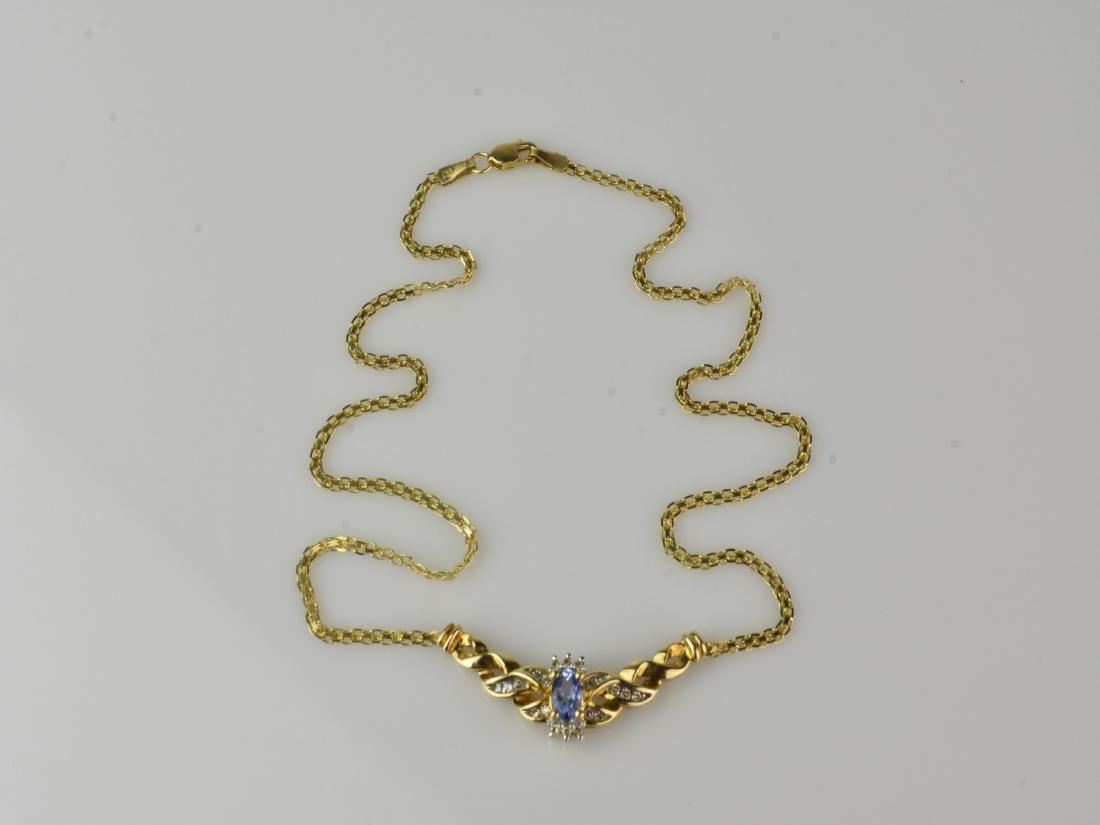 10 kt Yellow Gold & Tanzinite Necklace: 10 kt Yellow Gold Tanzanite Necklace with 20 single cut diamonds. Approx. total weight of diamonds is 0.17ct. Tanzanite measures 6mm x 4mm x 3mm.