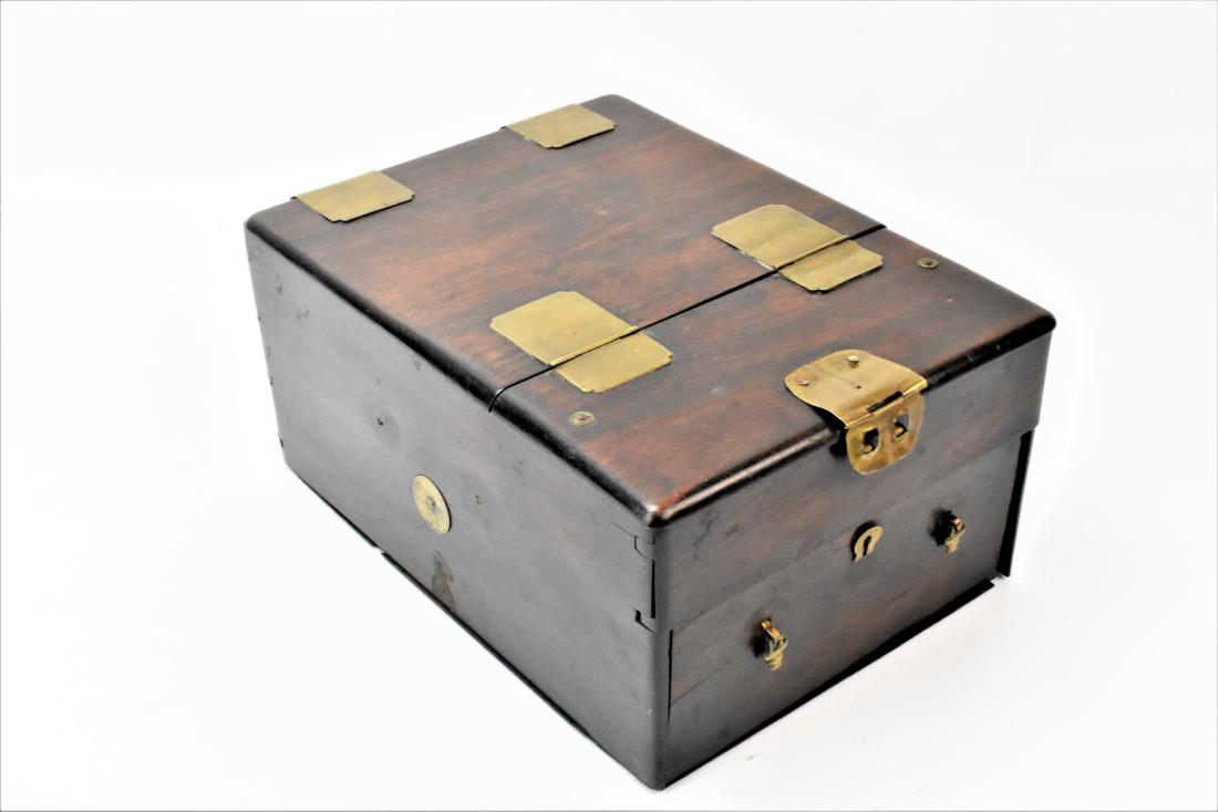 Antique Chinese Rosewood Traveling Vanity: An extremely fine example of an antique Chinese campaign style traveling vanity. Has a compartmented drawer with some loss to the escutcheon Hand dove tailed case, retains its original varnish, origin