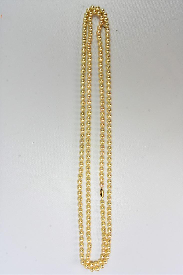 Pearl Necklace: Mikimoto quality Pearl Necklace with 14kt Gold clasp. Single strand double length, measures 69 inches.