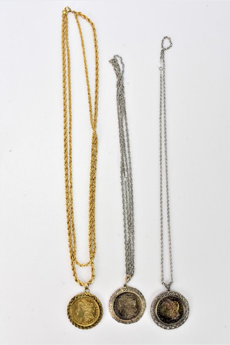 Morgan Silver Dollar Necklace Grouping: Group consists of ; Three Morgan Dollars, One dated 1878 with Sterling Chain, One dated 1878 with Sterling Chain and Bezal and One is dated 1880 with Gold plated Bezal and chain.
