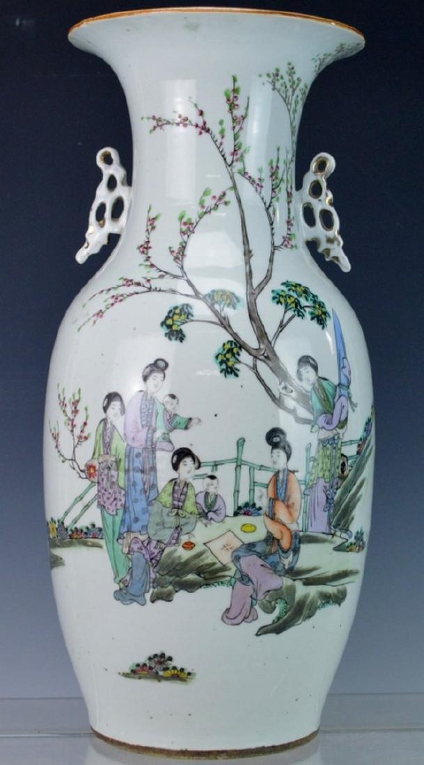 Antique Chinese Porcelain Vase: A fine Antique Chinese porcelain vase in palace form. One handle or ear decoration has minor older repair. Decorated with (7) women and children, with trees that appear to be cherry blossoms, shrubs, 