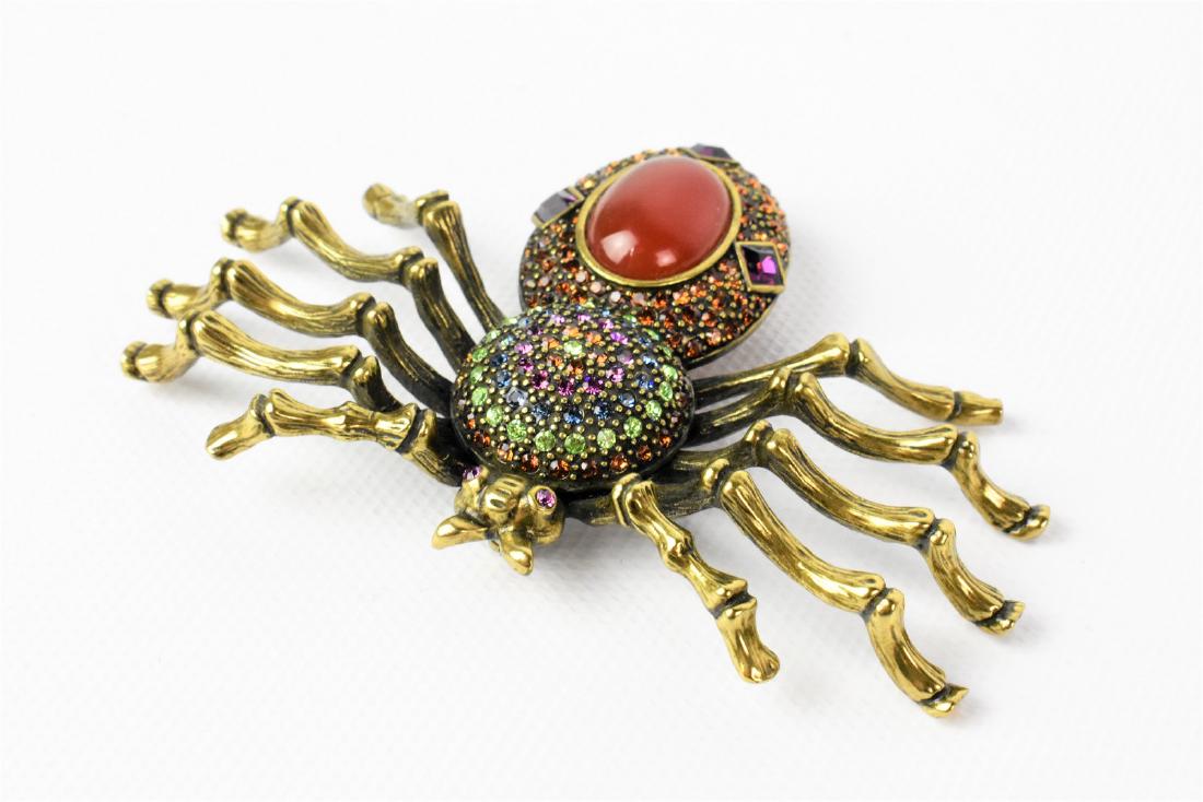 Heidi Daus Spider Brooch: A HEIDE DAUS FIGURAL FAUX CARNELIAN GLASS RHINESTONE SPIDER BROOCH measuring approx. 3.75"w. Comes with box and COA