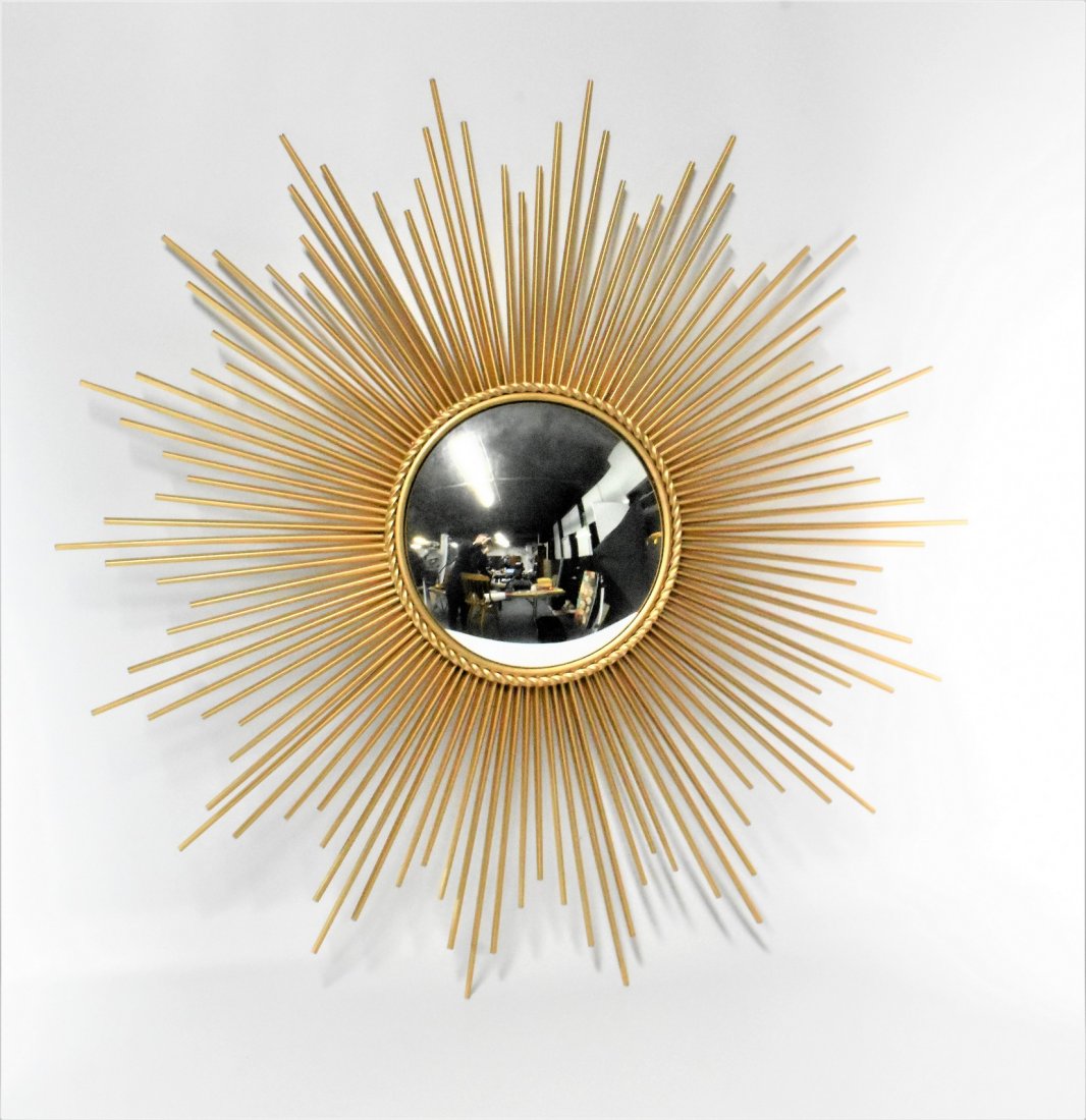 Mid Century Modern Style Sunburst Mirror: A MCM Style Sunburst Mirror measuring approx. 40"w