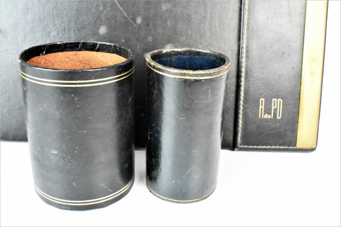 Mark Cross Desk Mat and Accessories Dupont Estate: Mark Cross Desk Mat and Accessories from the Dupont Estate with brass mounts, along with two leather cups for pens. The smaller cup has a chip on it. Also included is a business card holder for Alfred