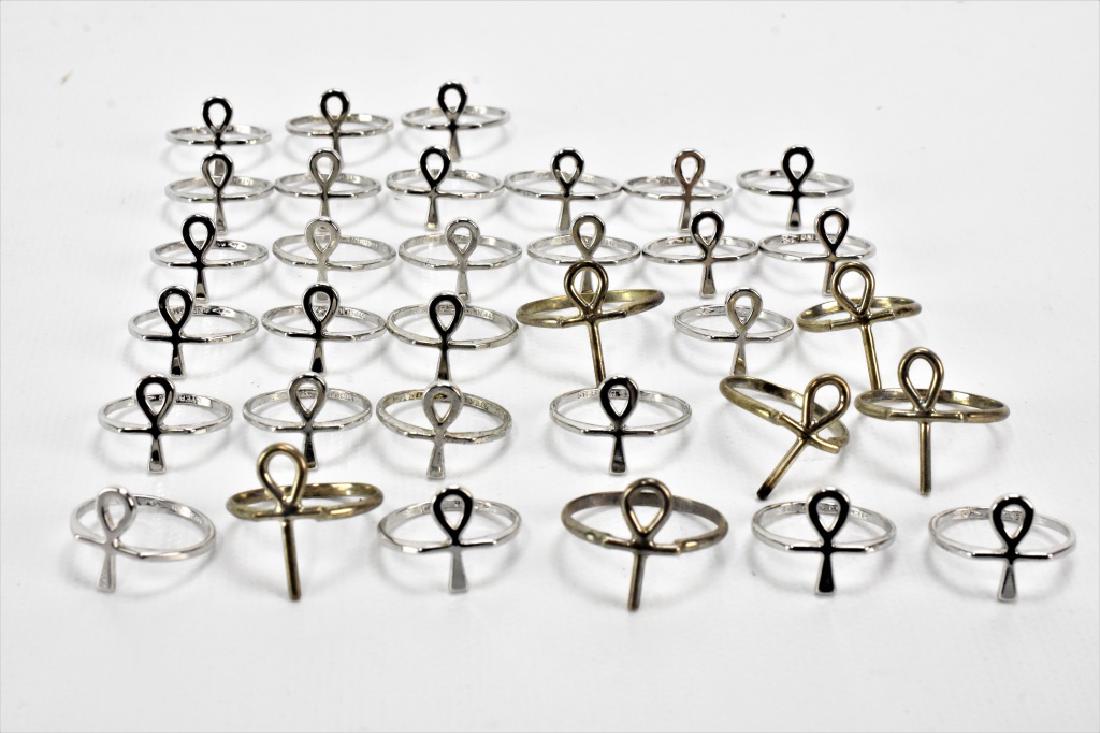Sterling Silver Ankh Ring Grouping: Grouping includes (33) Sterling Silver Rings with the ancient Egyptian hieroglyphic symbol known as the 'ankh,' which was used to represent the word Life. Its use has continued through the Coptic Egyp