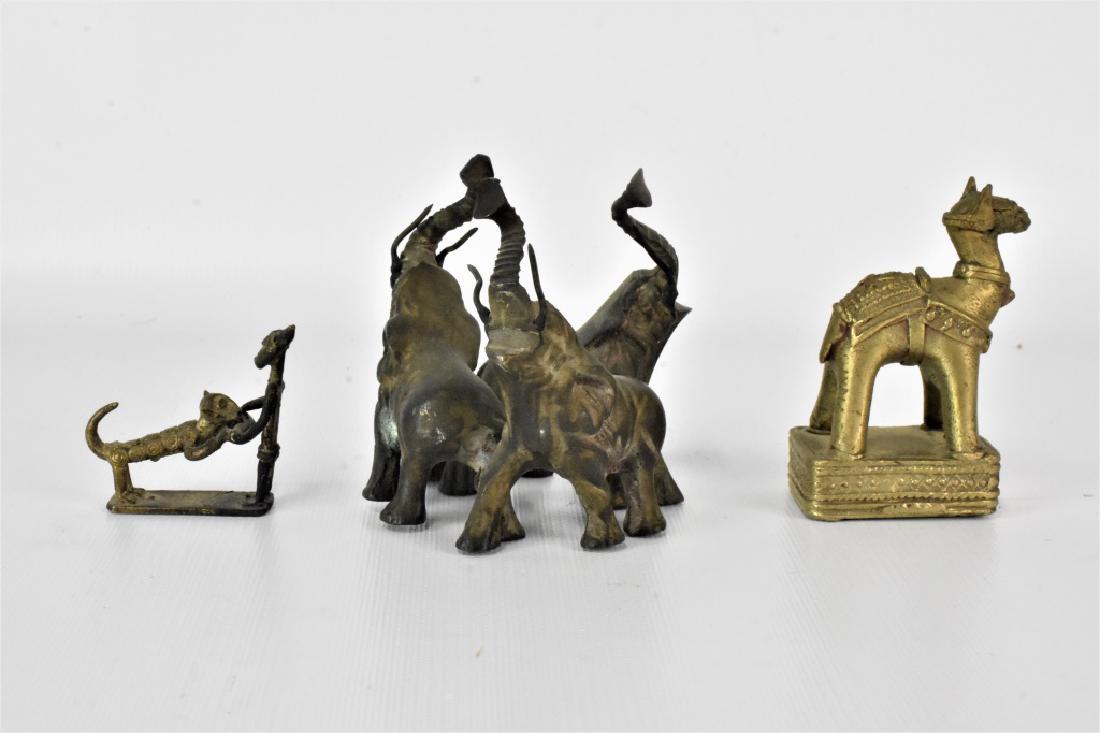 African and Islamic Figural Grouping: Grouping includes one sculpture of (3) Elephants cast in Bronze or Iron, a Silvered metal Camel in Islamic form, and a small sculpture of a Benin style man and Lion cast in a copper alloy or Bronze