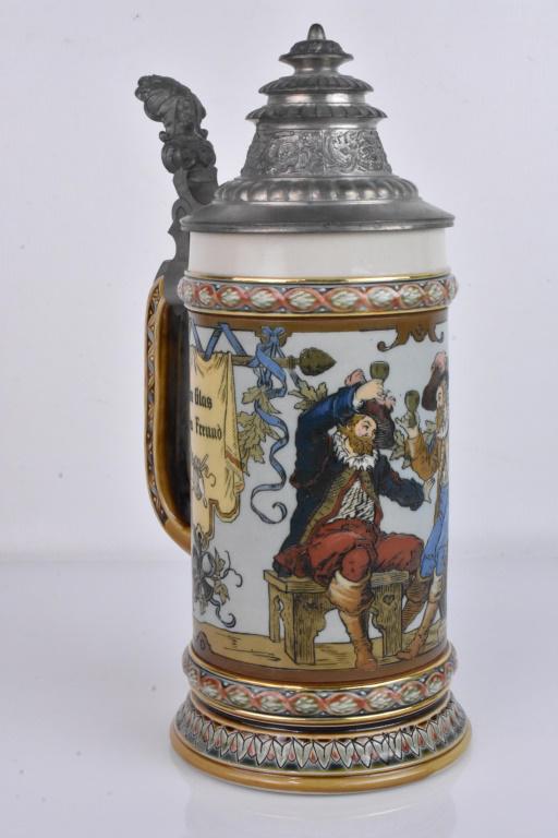 German Mettlach Cavaliers Stein: GERMAN METTLACH CAVALIERS DRINKING CERAMIC STEIN, number 1932, having etched sides with scene of two men in cavalier-type clothing drinking beer, flanked by two banners reading "Ein Glas beim Freund /