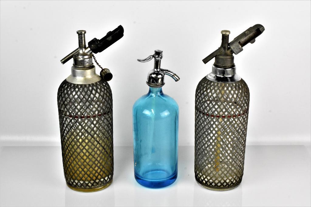 Blue Glass Seltzer Bottle Grouping: Sparklet Water Dispensor Grouping (3) Two clear Sparkelt water dispensors with mesh pattern and One blue G. Borak seltzer water container.