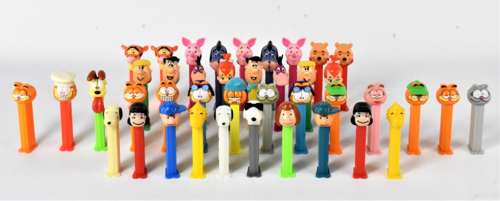 Pez Character Dispenser Grouping: Grouping includes (40+) character pez dispensers incluidng Winnie the Pooh, Flinstones, Garfield, and Peanuts.