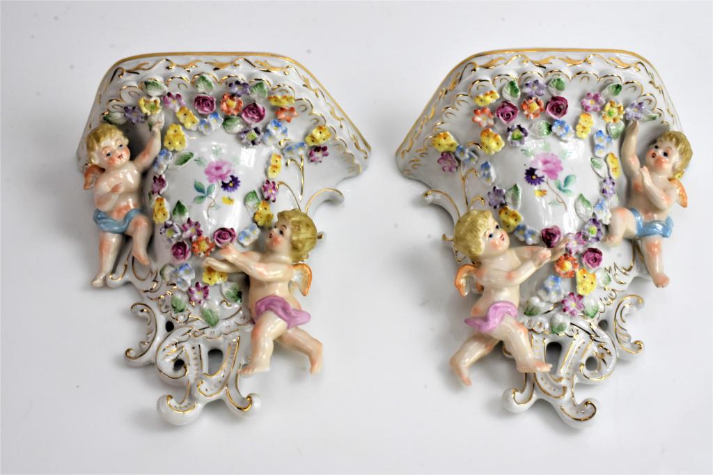 German Porcelain Style Wall Brackets: Each shelf measures appros 8 inches tall and 8 inches wide. Floral decorated putti or angels.
