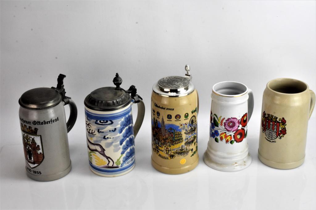 German Beer Stein Grouping: Lot of 5 includes Konig Pilsner 1984 stag beer stein, German beer stein celebrating 125 years of Octoberfest, another is from Hamburg, 2005 Octobefest beer stein made by WS. Hungarian beer mug, bottom