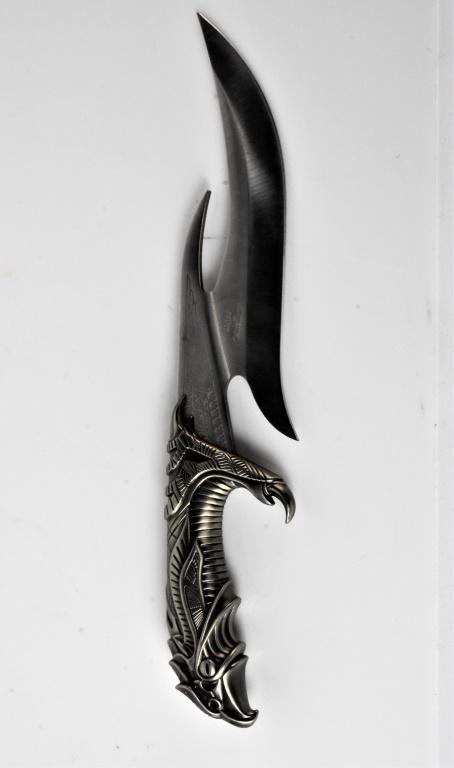 United Fantasy Dagger: Blade is marked United UC1229. Stainless Taiwan. Design 2000 UCC. Handle stylized as an Eagle. Knife rests in a dark wood stand. Blade is VERY SHARP.