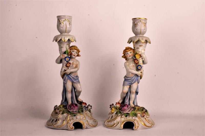 Schierholtz Candelabra Grouping: Grouping includes a pair of Schierholtz, (Meissen or Dresden style) hand-painted figural candelabras; appear to be in good condition with minor loss to leaves and flowers. Measure approx. 10"h
