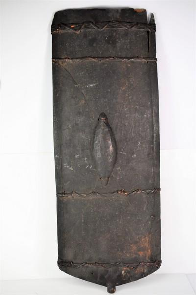 Antique East African Combat Shield: A carved East African tribal combat shield circa late 19th to early 20th century measuring approx. 33"h by 13"w Provenance: From the estate of a retired teacher and art conservator-restorer. This lot 