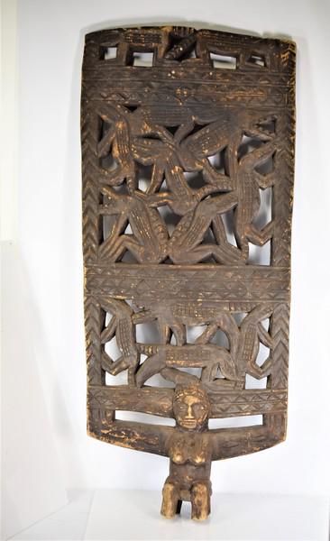 African Figural Shield: Includes a large carved African ceremonial figural shield. Measures approx. 53.5"h by 23.5"w Provenance: New Jersey estate
