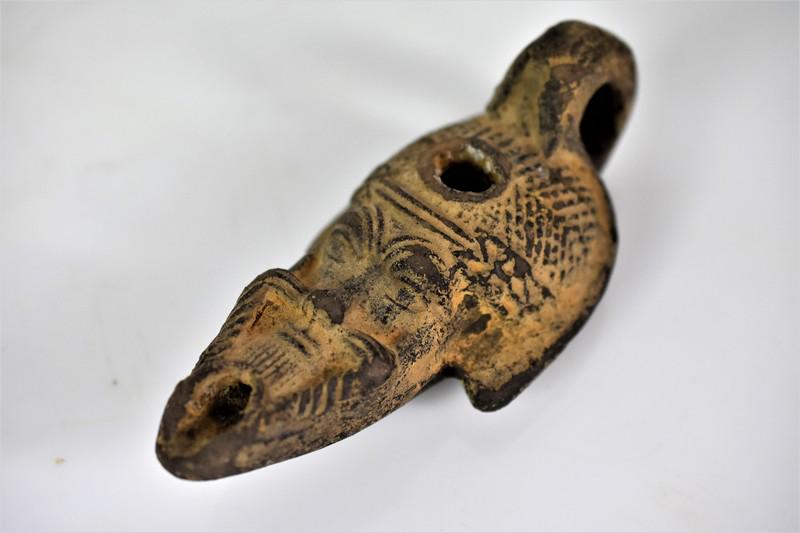 Ancient Roman Pottery Lamp in Figural Form: Includes an antique Roman style oil lamp measuring approx. 5.5"l Original ancient lamp. 1st-3rd century AD. Provenance: Private collection, part of a collection that toured the United States in the 19