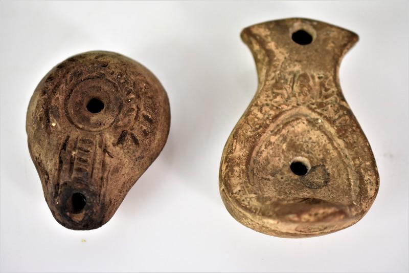 Ancient Roman Pottery Lamp Grouping: Grouping includes (2) antique oil lamps, the largest measuring approx. 3.75"l by 2.25"w by 1.5"h. 1st-3rd century AD.Provenance: From a private collection which previously toured the United States, du