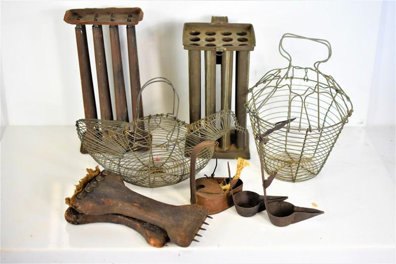 Primitive Grouping: Grouping includes (9) pieces including (2) candle molds, (2) wire egg baskets, (3) oil lamps, and (2) tools used for wool. Largest piece measures approx: 10.5"