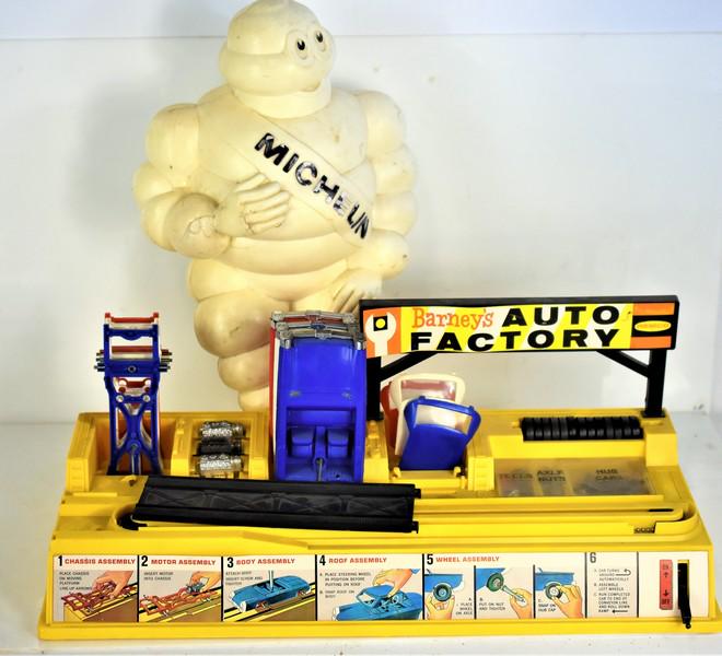 Michelin Man & Barneys Auto Factory Toy Grouping: Includes (3) bodies, (3) frames, (3) engines, (13) tires, and misc. hubcaps, tools, body bolt, and axlf nuts. Piece measures approx. 22.5" by 9" by 8" Michelin Man is in as-is condition.