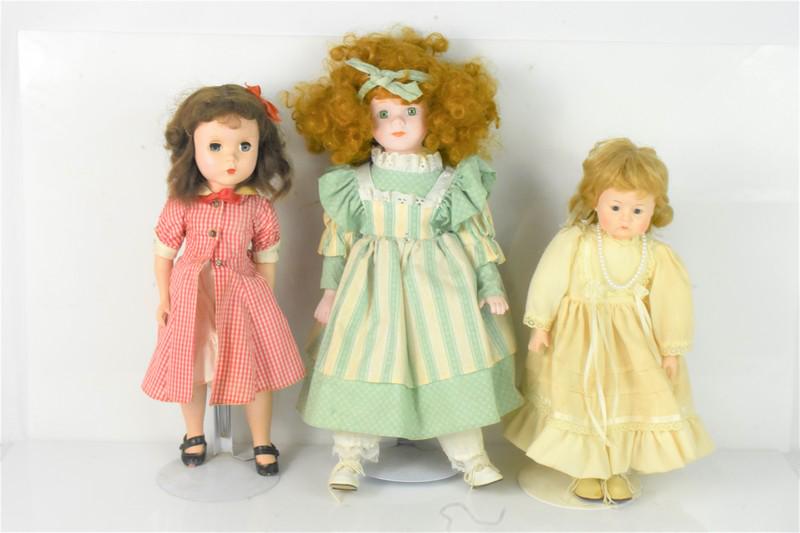 Vintage Collectible Porcelain Doll Grouping: Grouping of (3) Vintage Collectible Dolls with Stands. Grouping Includes (1)1989 Heritage Mint Redhead Porcelain Doll approx. 16"h , (1)Original Madame Alexander Maggie Walker Hard Plastic Vinyl Strun