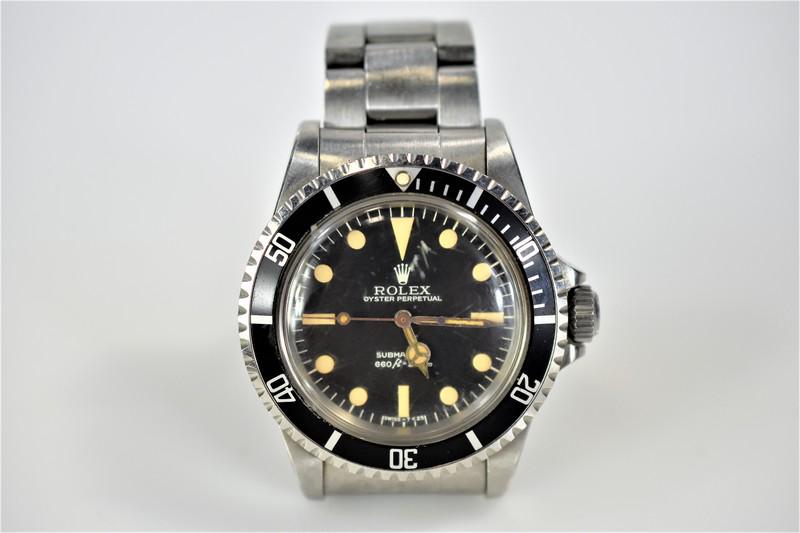 Vintage "Submariner" Rolex Watch: Includes a vintage Rolex watch, "Submariner" 40mm, no date. The watch ase, screw-down crown, oyster bracelet, flip-lock buckle, and rotating bezel are all stainless steel. The reference numbeer is 551