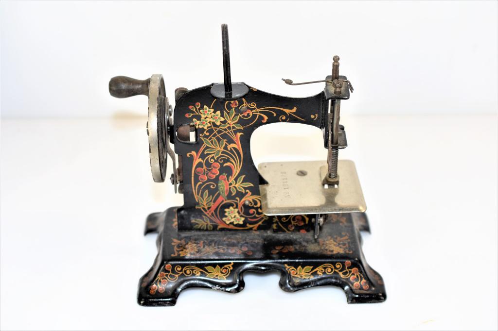 German Childs Miniature/Toy Sewing Machine: Includes: German Childs Miniature/Toy Sewing Machine marked made in germany with original paint. appx. 6.5" tall