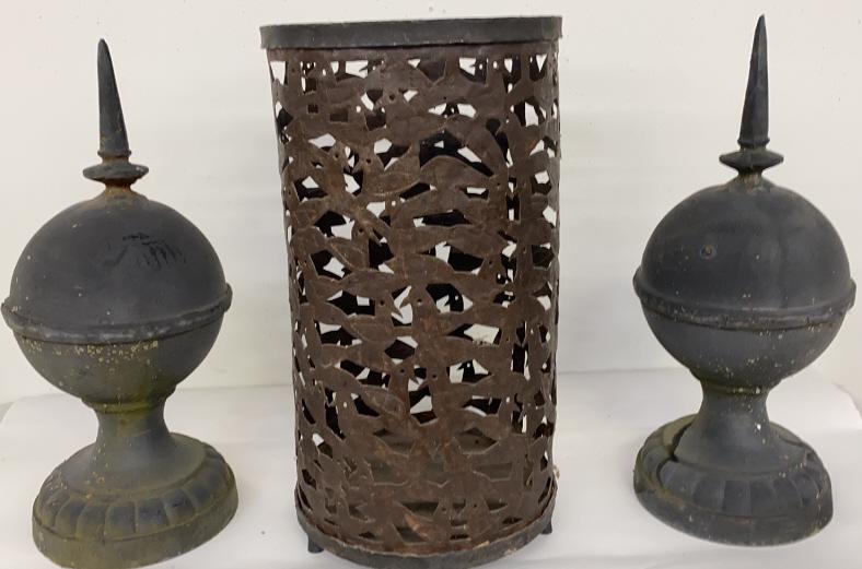 Cast Iron Garden Ornaments: (3) Includes cast iron umbrella stand, and 2 other cast iron decor pieces umbrella stand is approximately 20 inches tall and 9 inches in diameter. Ornaments are approximately 18 inches tall.
