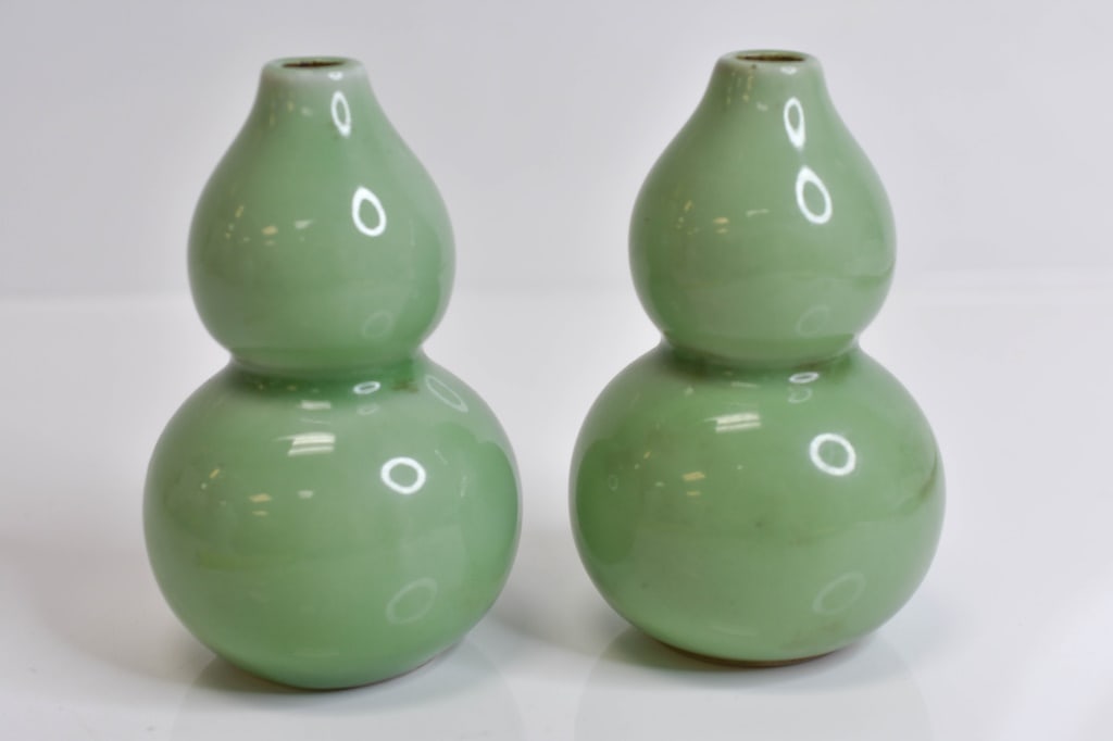 Antique Chinese Celadon Double Gourd Vases: Beautiful Pair of Antique Chinese Double Gourd Celadon Vases. These are believed to be from the 19th century with a nice glaze on both. Rims are not perfect, however, this is not due to damage, these