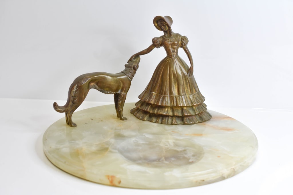 Art Deco Onyx Bronze Dog and Woman Sculpture: Bronze or brass? Measures 14 inches in diameter.