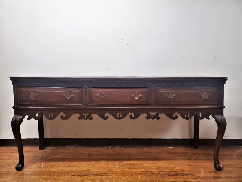 George III Chippendale Huntboard Circa 1780: A fine George III oak Chippendale huntboard resting on cabriole legs with carved knees and ball and claw feet, circa 1760-1780.