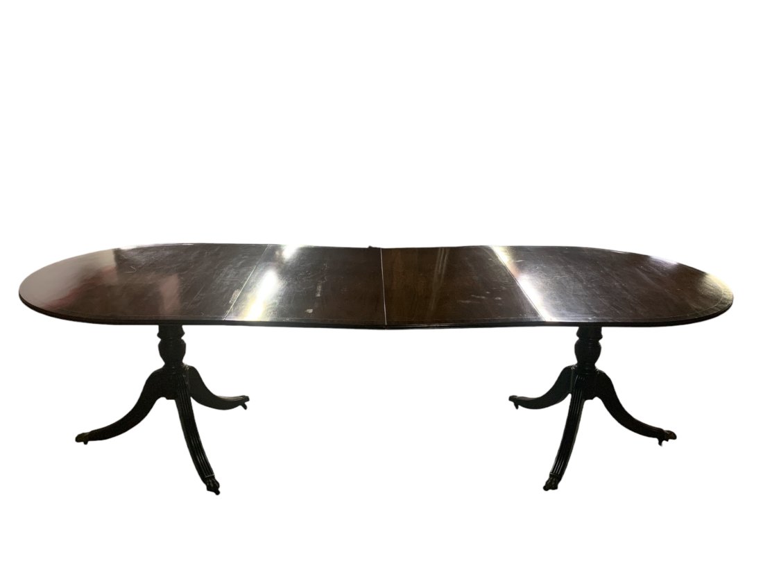 Mahogany Banded Top Dinning Table: Approximate measurement table is 63 inches long by 40 inches wide. Table comes with two extension leaves. Each leaf is 20 inches wide. Chairs not included. Provenance: From the estate of a New York ba
