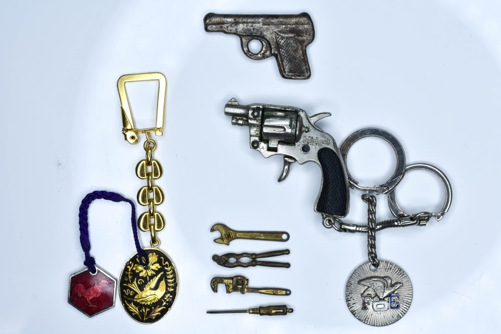 Key Chains and Trinket Lot: Includes mini tools, hand gun trinket, various key chains including a "Midget" revolver