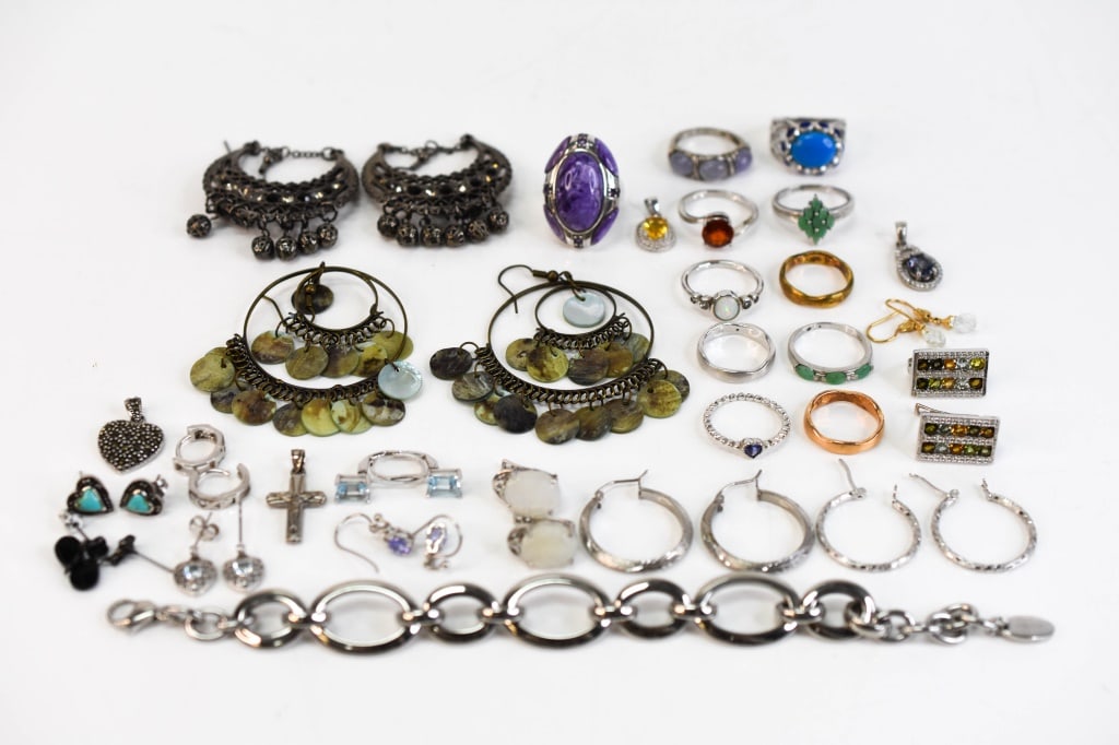 Sterling Silver Jewelry & More: Grouping includes (11) sterling silver rings, (8) include various untested stones. (6) sterling silver pieces including (4) earring pairs (2 with stones), as well as a crucifix pendant and sterling si