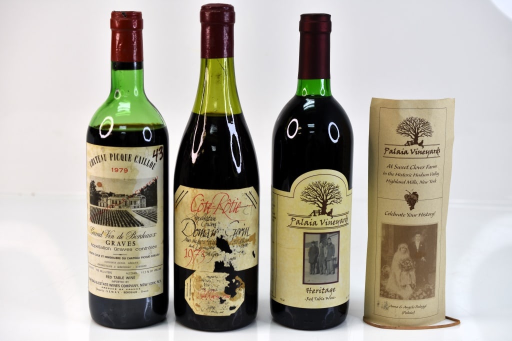 Chateau Picque Caillou Wine & More: Grouping includes (3) 1973 bottles of red wine including (1) Cote-Rotie Domain Gerin, (1) 1979 Chateau Picque Caillou, and (1) Palaia Vineyards Heritage Red Table Wine. One bottle appears to have a fi