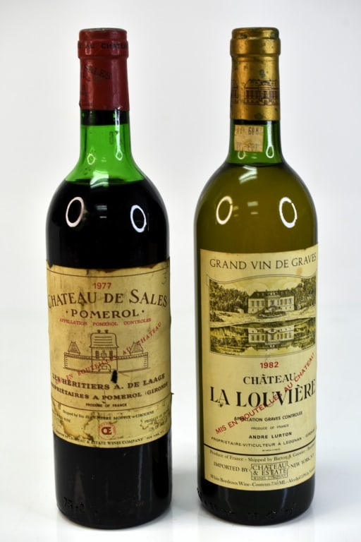 1977 Chateau de Sales Red Wine & More: Grouping includes (2) bottles including (1) bottle of 1977 Chateau de Sales red wine and (1) bottle fo 1982 Chateau La Louviere white bordeaux wine. This fine wine is part of an estate. It was stored 