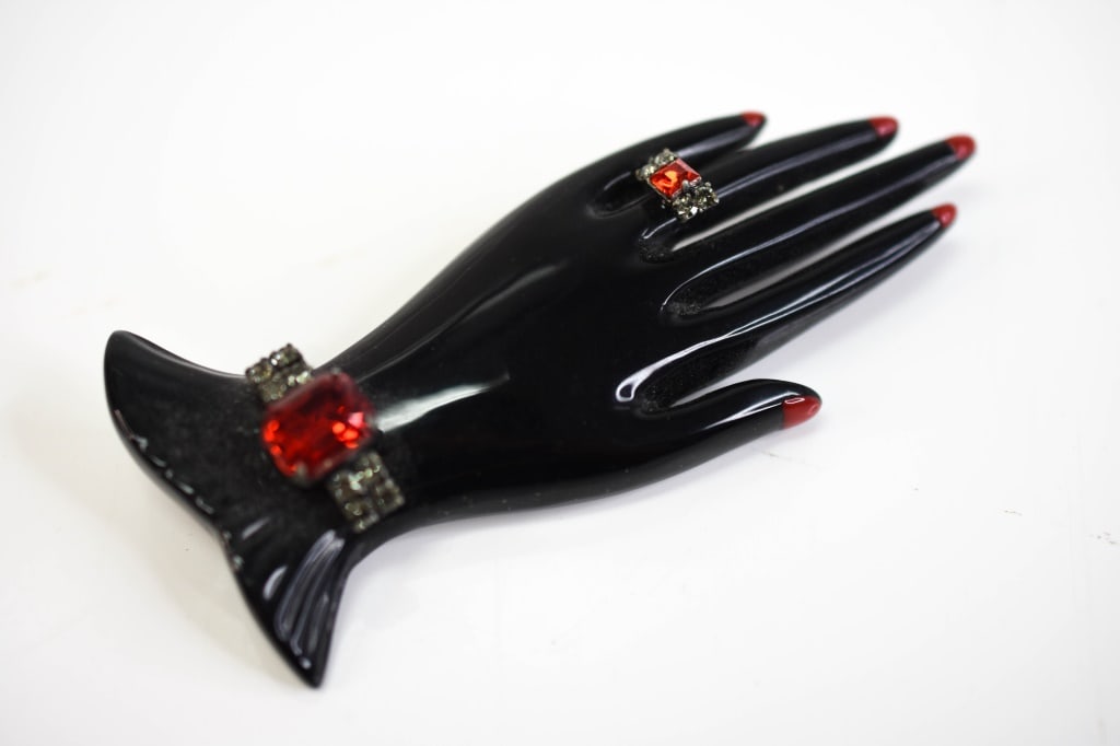 Marion Godart Jeweled Bakelite Black Hand: Hand measures approx. 3.71" wide, does have superficial loss; the ring on the hand has separated, but can be reattached.