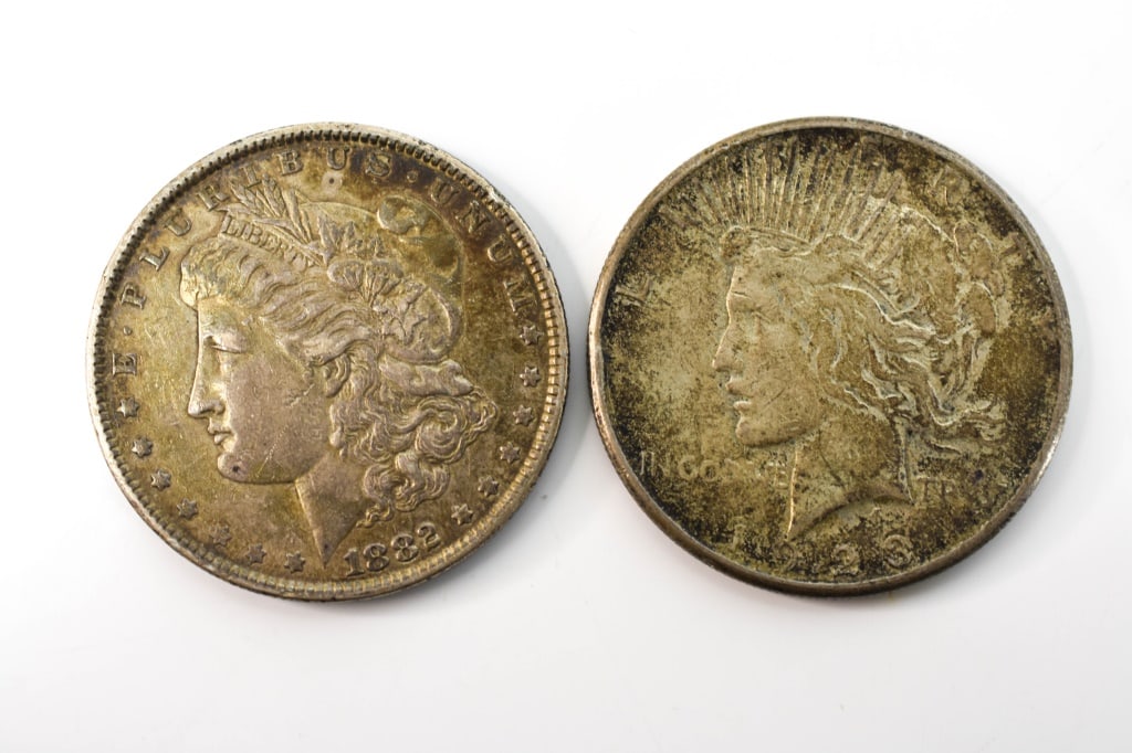 1882 Morgan Silver Dollar & 1923 Peace Dollar: 2 coins 1882 Morgan Silver Dollar & 1923 Peace Dollar Total weight is approx. 53.3 grams. Provenance: From a local Dresher, PA estate. Consignor states these were inherited from her parents. The colle