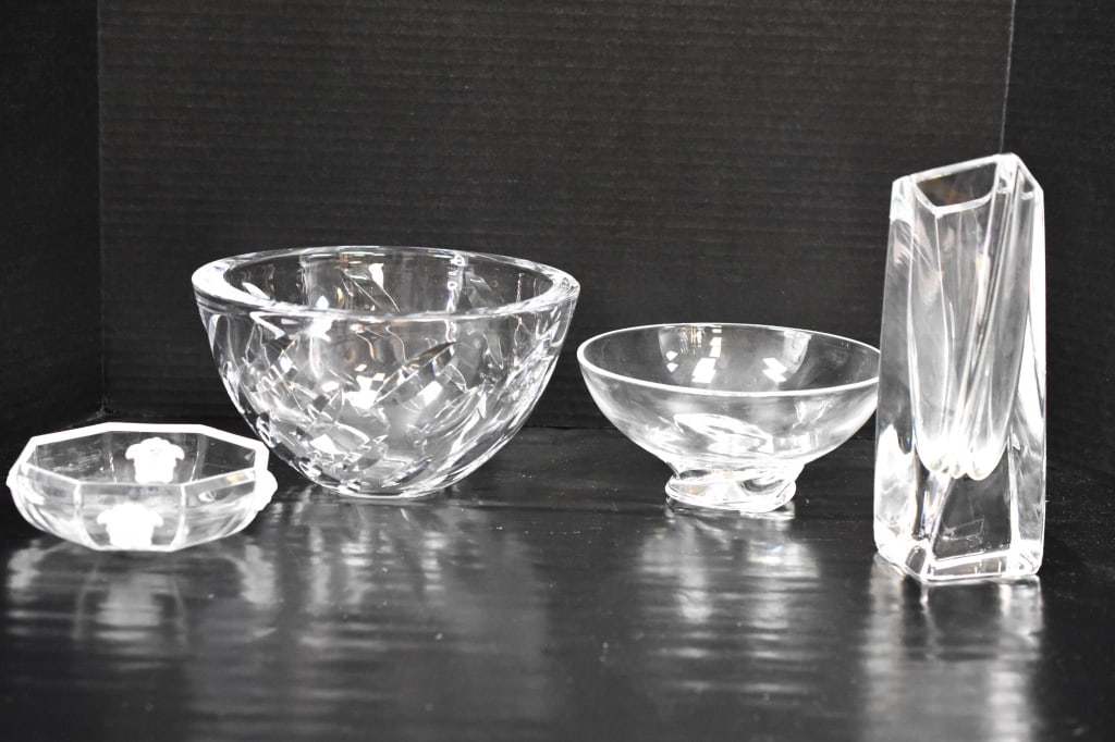 Signed Crystal Grouping: Grouping includes (3) crystal bowls and (1) crystal vase with makers such as Versace, Steuben, Kostaboda, and Sasaki. Vase measures approx. 9"h. Provenance: From a local Dresher, PA estate. Consignor