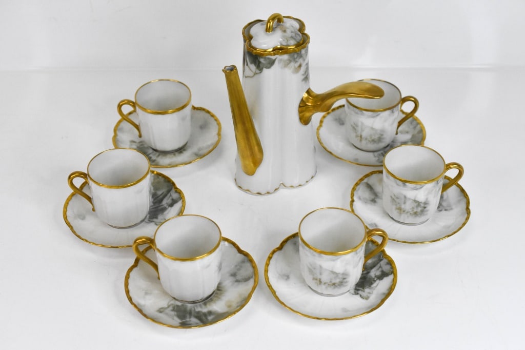 French Limoge Feu de Four Chocolate Pot Service: 12pc set includes: 1 Pot with lid, 5 cups, 6 saucers, hand painted floral with gilt accents. Signed. Approx. dimensions H: 6 3/4".very good condition, looks brand new and unused except for one minor f